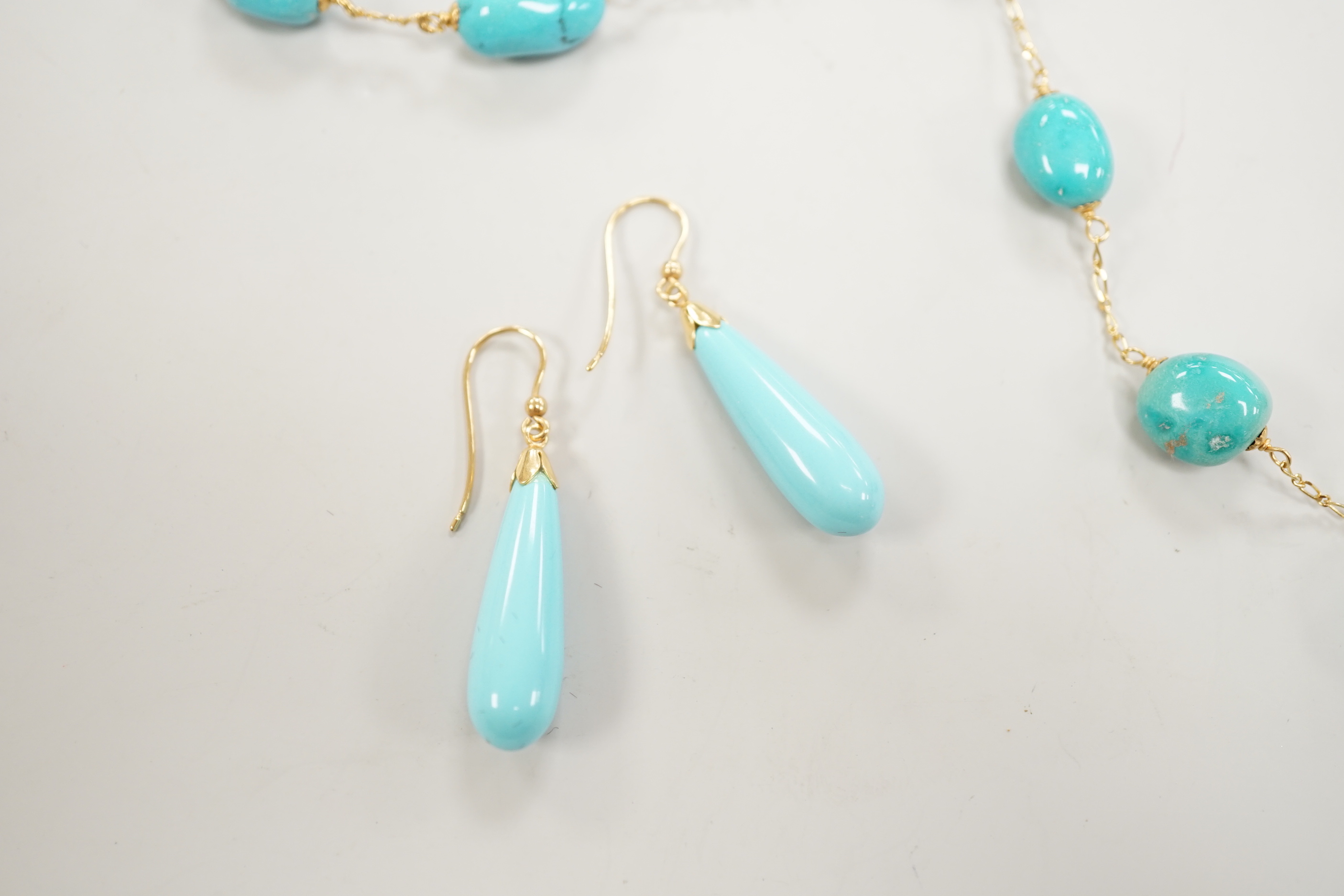 A modern Italian 750 and turquoise bead set necklace and matching bracelet, (necklace knotted) and a pair of similar enamelled? earrings, gross weight 29.4 grams.